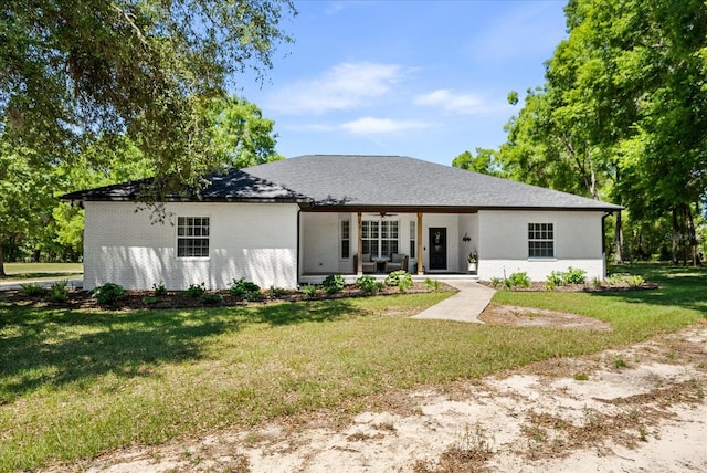 view of front of house with brick siding and a front yard