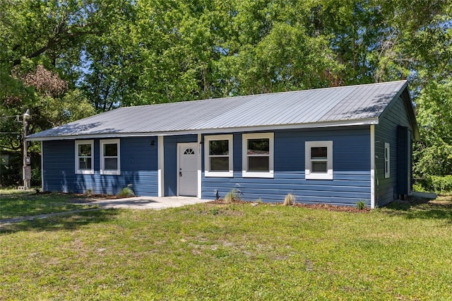 ranch-style house featuring a front lawn and metal roof
