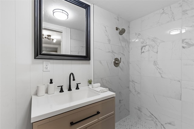 full bathroom with vanity and tiled shower