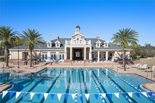 pool featuring french doors and a patio area