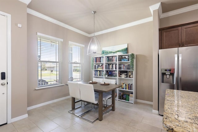 dining area featuring crown molding, baseboards, and light tile patterned flooring