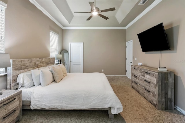 bedroom with light colored carpet, a raised ceiling, crown molding, and visible vents