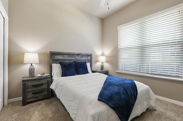 carpeted bedroom with baseboards and multiple windows