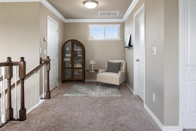 living area featuring carpet floors, baseboards, an upstairs landing, visible vents, and ornamental molding