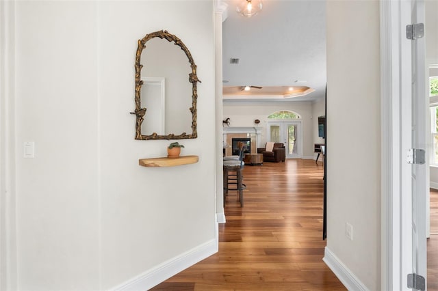 3624 SW 73rd Way, Gainesville, FL 32608 - hall with wood finished floors, a raised ceiling, baseboards, and crown molding