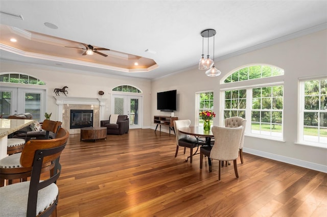 3624 SW 73rd Way, Gainesville, FL 32608 - dining room featuring french doors, wood finished floors, crown molding, a ceiling fan, and a tray ceiling