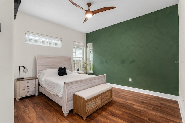 3624 SW 73rd Way, Gainesville, FL 32608 - bedroom with wood finished floors, baseboards, an accent wall, and ceiling fan