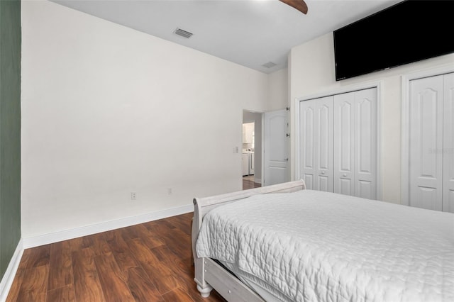 3624 SW 73rd Way, Gainesville, FL 32608 - bedroom with baseboards, dark wood-type flooring, two closets, and a ceiling fan
