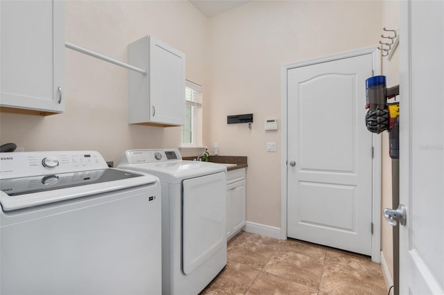 3624 SW 73rd Way, Gainesville, FL 32608 - washroom featuring cabinet space, washing machine and dryer, and baseboards