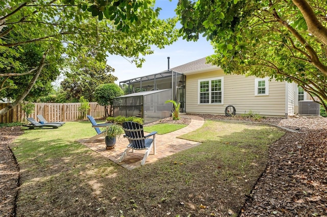 3624 SW 73rd Way, Gainesville, FL 32608 - view of yard with central AC, glass enclosure, and a patio