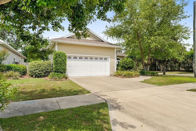 3624 SW 73rd Way, Gainesville, FL 32608 - view of front facade featuring concrete driveway, a garage, and a front lawn