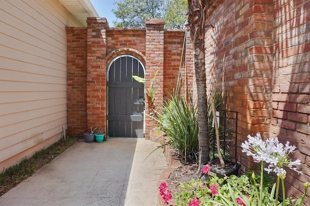 10321 NW 34th Ln, Gainesville, FL 32606 - doorway to property with brick siding and a gate