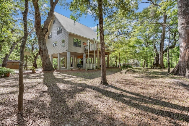 back of property with a deck and metal roof