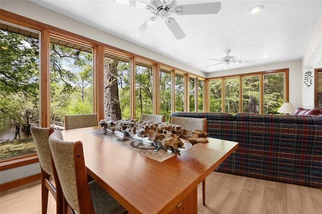 sunroom with a ceiling fan, outdoor dining space, and a healthy amount of sunlight