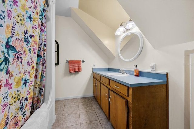 full bath with tile patterned floors, vaulted ceiling, baseboards, a shower with shower curtain, and vanity