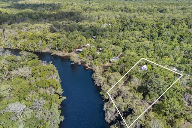 aerial view featuring a forest view and a water view