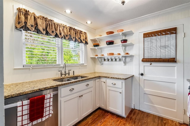 kitchen with white cabinets, wine cooler, a sink, crown molding, and light stone countertops