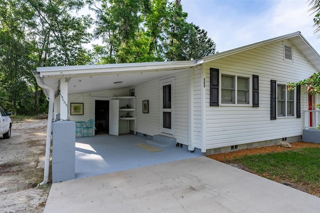 manufactured / mobile home featuring crawl space, a carport, driveway, and entry steps