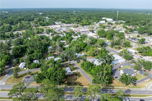 drone / aerial view featuring a forest view and a residential view