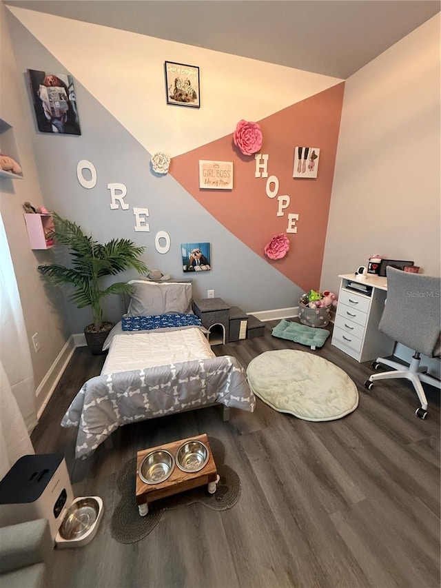 bedroom featuring baseboards and wood finished floors