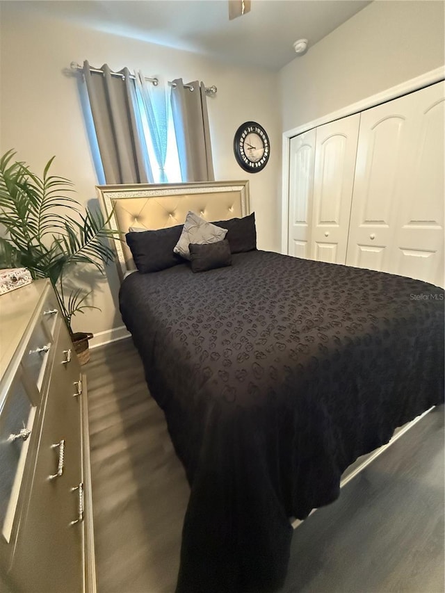 bedroom featuring a closet and dark wood finished floors