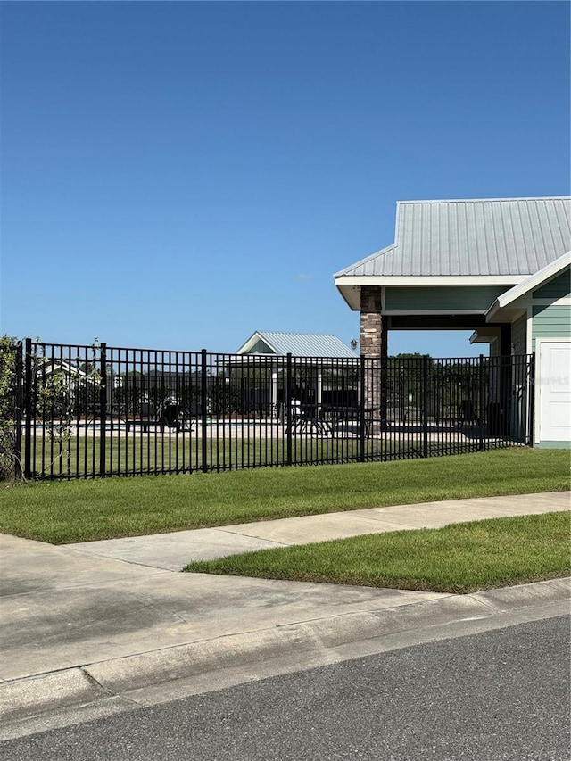 view of home's community featuring fence and a yard