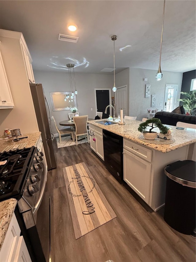 kitchen with a sink, visible vents, dishwasher, white cabinets, and gas range