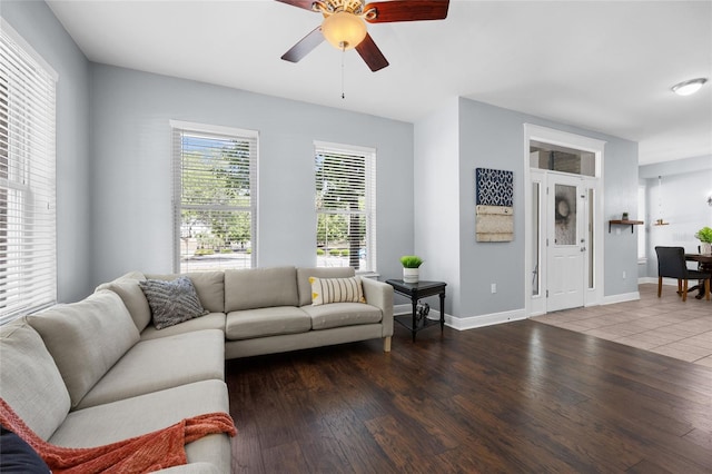 living room featuring a ceiling fan, wood finished floors, and baseboards