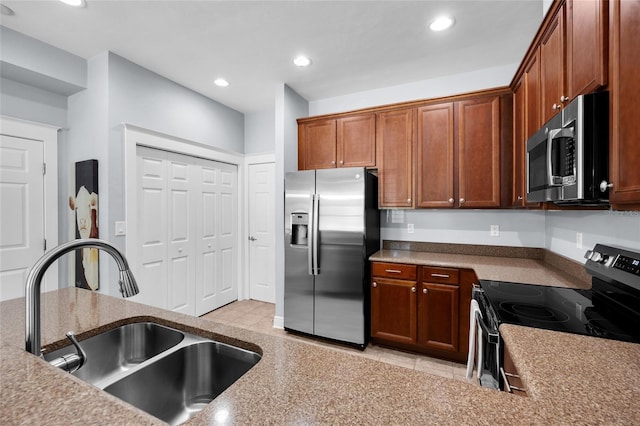 kitchen with appliances with stainless steel finishes, a sink, and recessed lighting