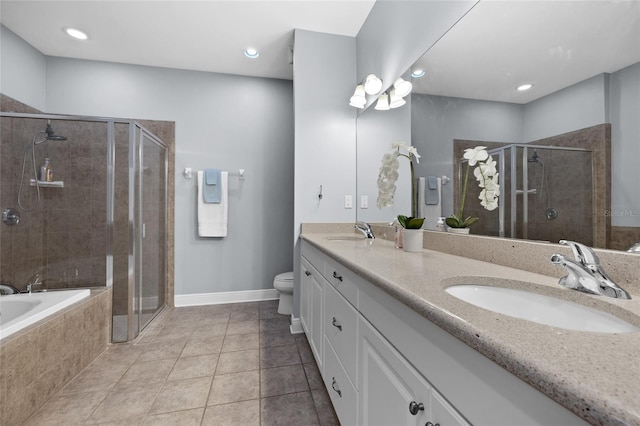 bathroom with a shower stall, baseboards, double vanity, tile patterned flooring, and toilet