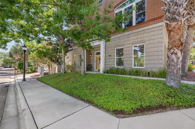 view of front of home featuring brick siding