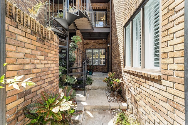 706 NE 1st St Unit 706, Gainesville, FL 32601 - property entrance featuring a balcony and brick siding