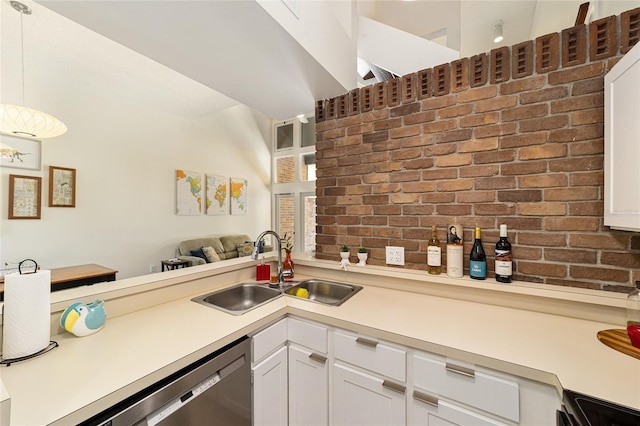 706 NE 1st St Unit 706, Gainesville, FL 32601 - kitchen with appliances with stainless steel finishes, brick wall, light countertops, and a sink