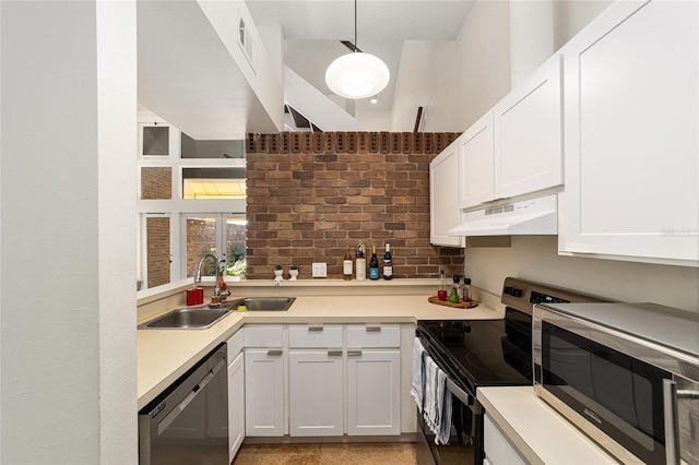 706 NE 1st St Unit 706, Gainesville, FL 32601 - kitchen with under cabinet range hood, appliances with stainless steel finishes, light countertops, white cabinets, and a sink