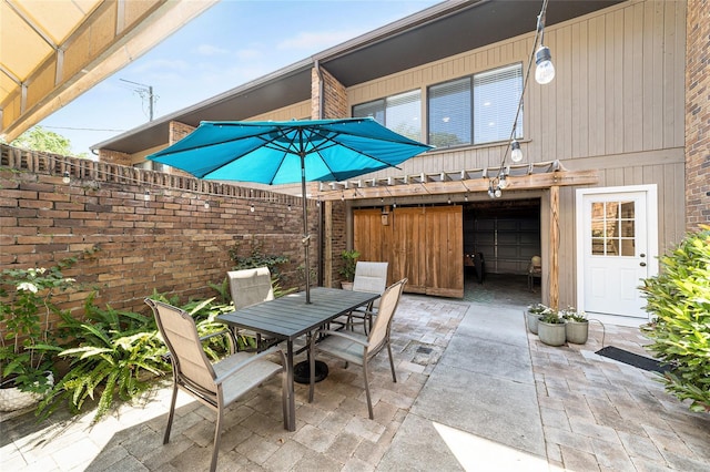 706 NE 1st St Unit 706, Gainesville, FL 32601 - view of patio / terrace with a garage, fence, and outdoor dining space