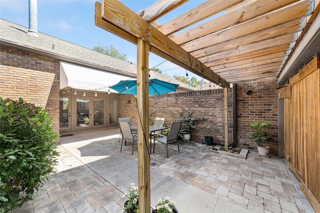 706 NE 1st St Unit 706, Gainesville, FL 32601 - view of patio / terrace featuring fence, a pergola, french doors, and outdoor dining area
