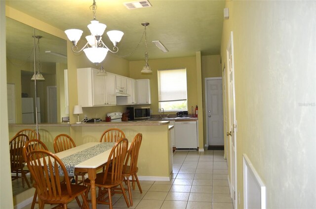 3870 SW 20th Ave Unit 1607, Gainesville, FL 32607 - kitchen with under cabinet range hood, white appliances, light tile patterned floors, a notable chandelier, and visible vents