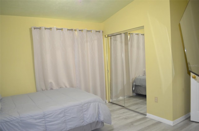 3870 SW 20th Ave Unit 1607, Gainesville, FL 32607 - bedroom with baseboards, wood finished floors, and a closet