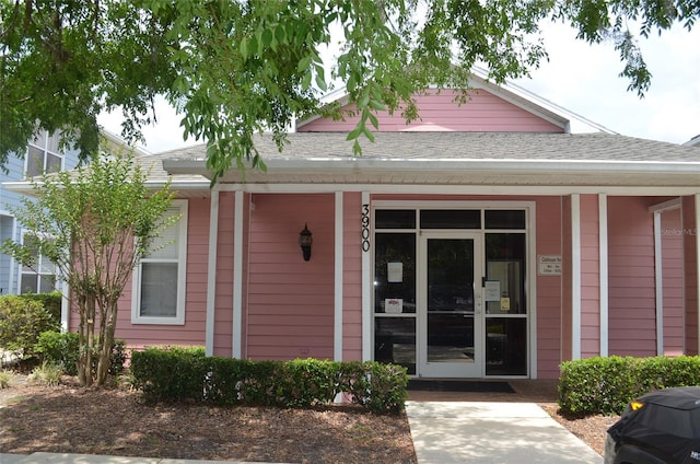 3870 SW 20th Ave Unit 1607, Gainesville, FL 32607 - view of front of home featuring roof with shingles and covered porch