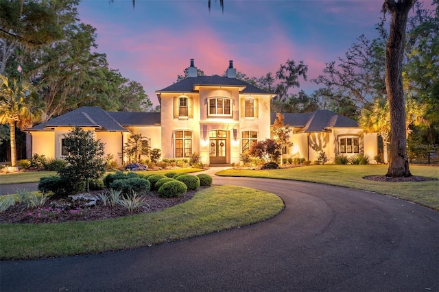 14819 NW 21st Ave, Newberry, FL 32669 - french country style house with a front lawn, a chimney, and stucco siding