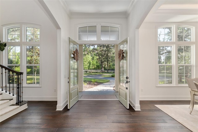 14819 NW 21st Ave, Newberry, FL 32669 - entryway with dark wood-style floors, arched walkways, baseboards, stairway, and ornamental molding