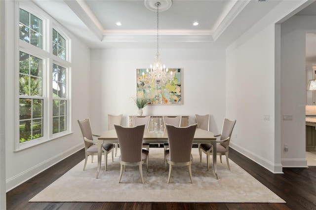 14819 NW 21st Ave, Newberry, FL 32669 - dining space featuring baseboards, a notable chandelier, crown molding, dark wood-type flooring, and a raised ceiling
