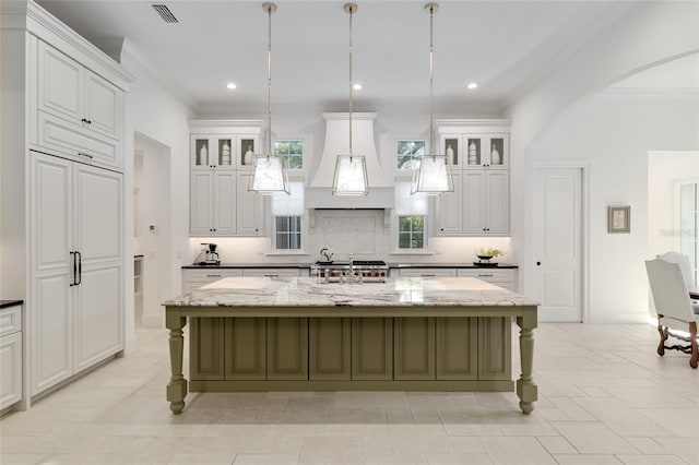 14819 NW 21st Ave, Newberry, FL 32669 - kitchen featuring arched walkways, white cabinetry, and ornamental molding
