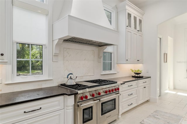 14819 NW 21st Ave, Newberry, FL 32669 - kitchen featuring dark countertops, premium range hood, backsplash, and double oven range