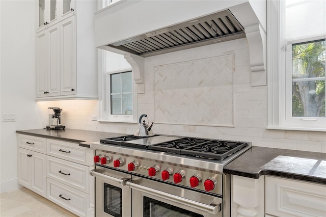 14819 NW 21st Ave, Newberry, FL 32669 - kitchen featuring premium range hood, backsplash, dark countertops, and range with two ovens