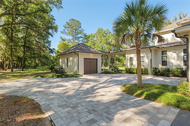 14819 NW 21st Ave, Newberry, FL 32669 - view of front of property with an attached garage, stucco siding, and driveway