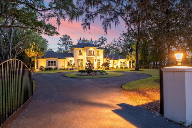 14819 NW 21st Ave, Newberry, FL 32669 - view of front of property with a chimney, a front lawn, stucco siding, and curved driveway