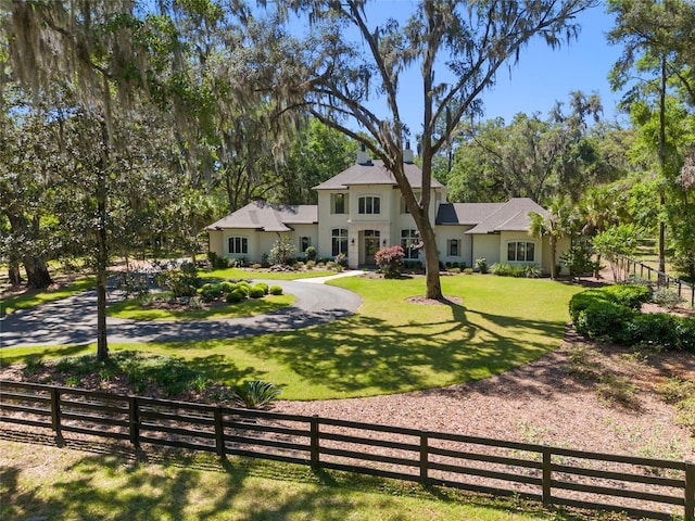 14819 NW 21st Ave, Newberry, FL 32669 - colonial inspired home featuring fence private yard, a front yard, and stucco siding