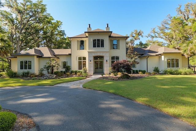 14819 NW 21st Ave, Newberry, FL 32669 - view of front facade with a chimney, stucco siding, french doors, and a front yard