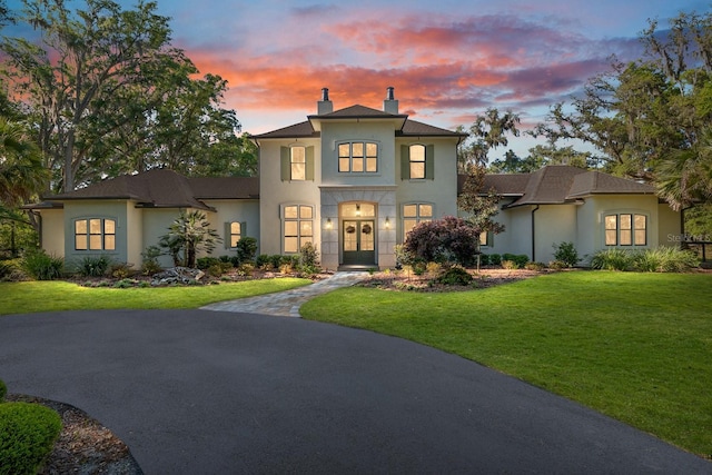 14819 NW 21st Ave, Newberry, FL 32669 - view of front facade with a lawn, a chimney, french doors, and stucco siding